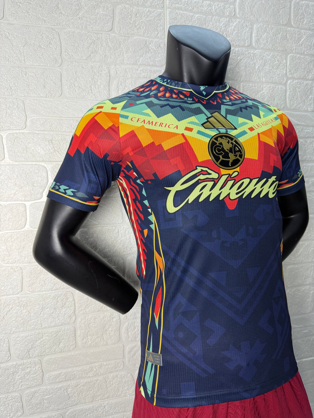 2025/26 Club América Training Player Version Jersey - Dark Navy Blue Body Multicolour Aztec Zigzag Graphic Upper Chest -Gold Three Stripes - Club América Crest - Caliente Principal Sponsor